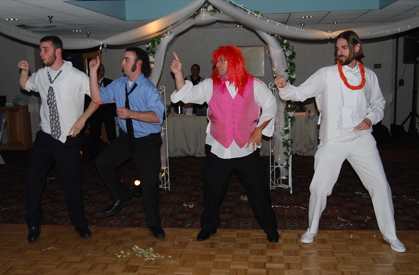 Wedding guests in costume props during a dance activity