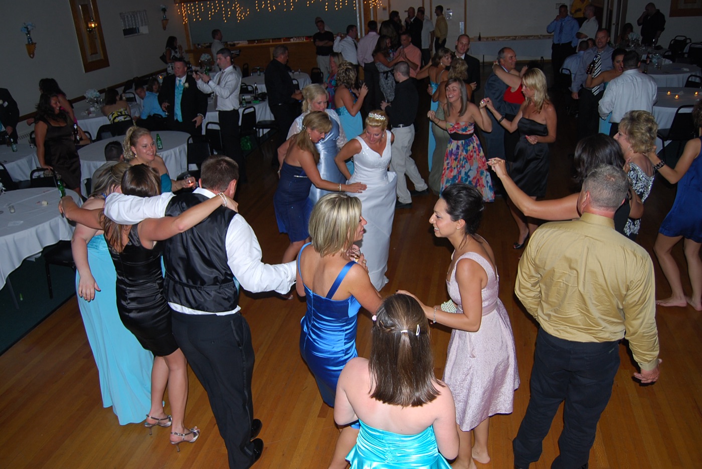Wedding guests dancing together on a packed floor