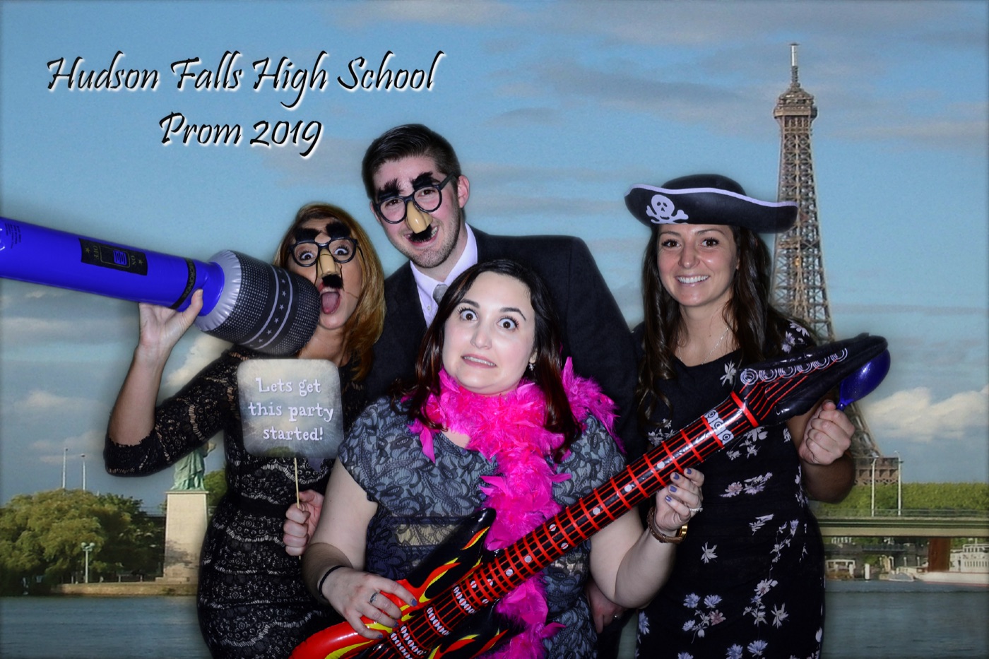 Students posing at a prom photo booth
