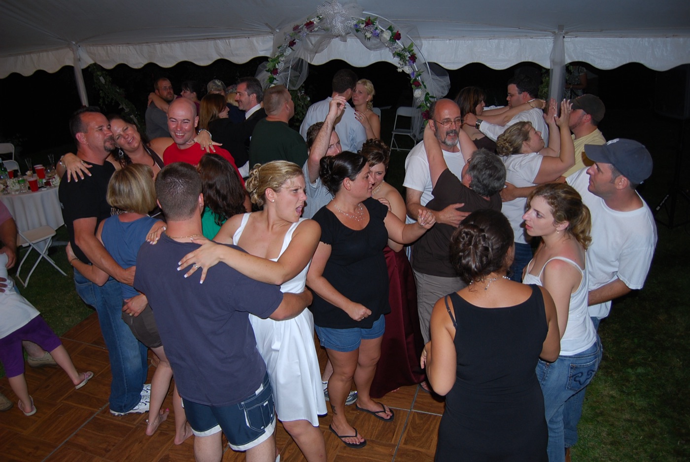 Guests dancing at an outdoor tent wedding