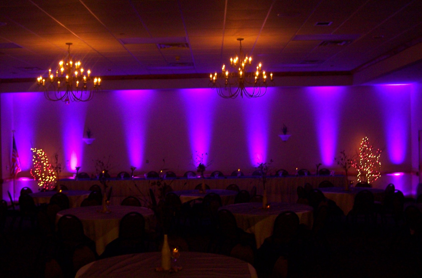 A ballroom washed in purple uplighting